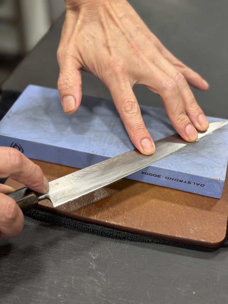 Sharpening a knife, symbolizing autophagy and cellular cleanup during fasting